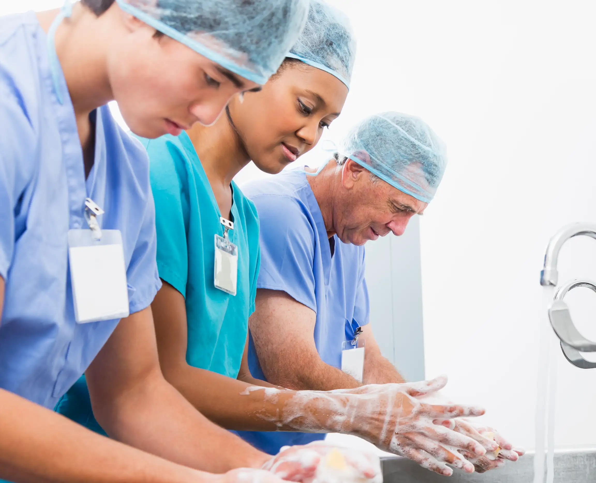 Surgeons preparing for surgery by washing their hands.
