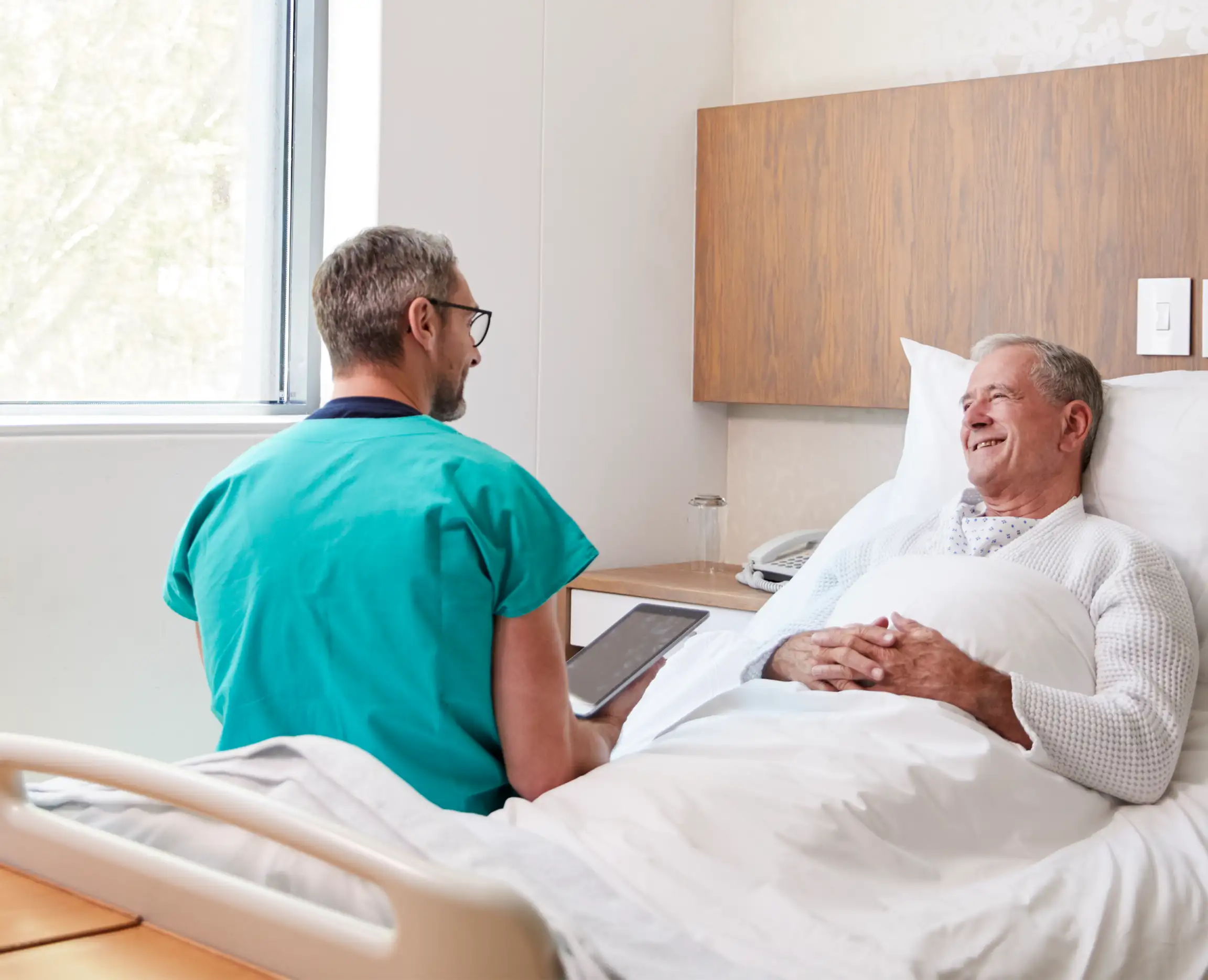 Doctor and patient have a bed side conversation.